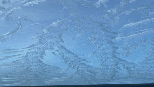 Stunning natural winter ice patterns on a frozen car window, Wonderful snowflakes on the glass, High quality video in FullHD format.