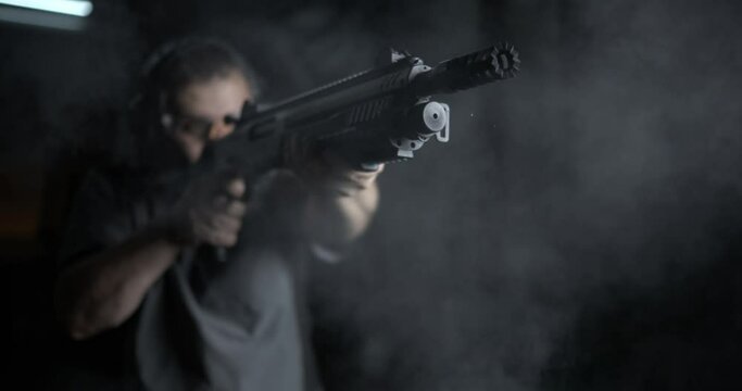 Man Firing Shotgun Captured in 800fps Super Slow-Motion, High-Speed Shooting, front view of person aiming power weapon\