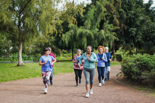 Group of senior people doing running sport workout at city park - Healthy elderly lifestyle concept