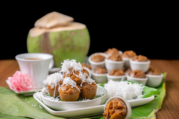 Steamed palm-sugar cupcake or Kanom Pum with grated coconut on top, cake is one of type traditional snack from Phatthalung Province, Thailand. Thai southern sweet dessert for snack.