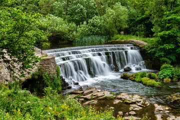Weir on the river Wye in Monsal Dale in the Peak District in Derbyshire, England