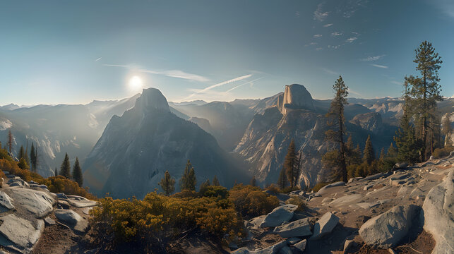 A panoramic view of a mountain range with a sun shining on the peaks - Powered by Adobe