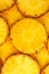 Pineapple juicy yellow slices as a background.