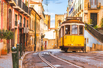Lisbon city old town and famous yellow tram 28 with Santa Maria cathedral on background. Lisbon,...