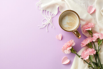 Breakfast with love for Mom: A Mother's Day setting with a cappuccino, fresh carnations, and paper...
