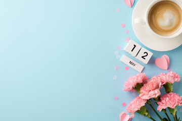 Mom's Day agenda: A top-down look at fresh carnations adjacent to a May calendar, signifying...