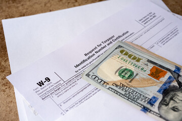 American dollars on W-9 tax certificate in close-up