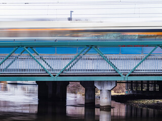 Speeding Tram Passing Over a Blue Bridge in Gothenburg, Sweden at Dusk