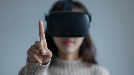 A person with headset touches a virtual screen in air with finger.