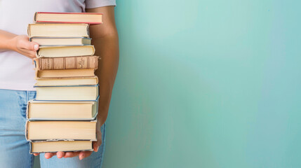 woman holding stack of books