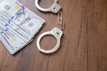 handcuffs and dollars