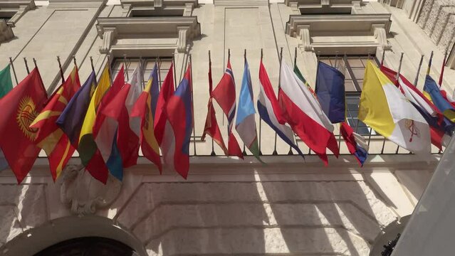 Vienna, Austria Flags of the world blowing in the wind on the Hofburg Palace.