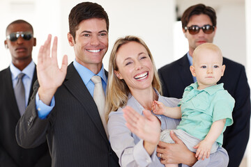 Fototapeta premium Waving, politician and couple with security at legal conference for political decision with crowd and fame. Leader or representative with guard and family with baby for alert and protect in public