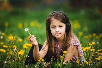 Portrait of a serious sweet girl wearing headphones. - 776202379