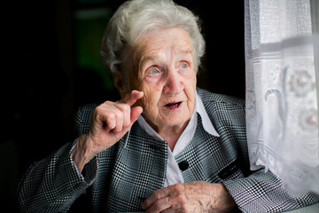 An elderly woman speaks passionately. - 776202391