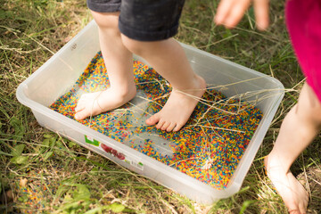 children's feet treading on colorful rice