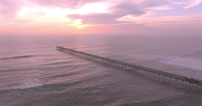 Shot of dock at sunset, with the seafront behind. Aerial shot of the Puerto Eten beach sea at sunset.