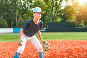 Young teen boy play baseball on a playground