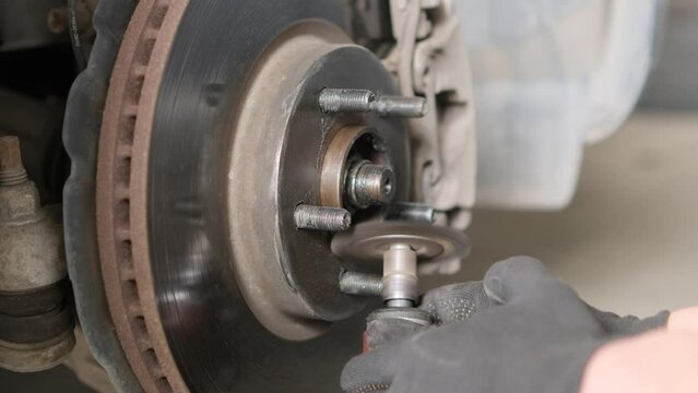 Sanding car brake disc joint in the repair shop