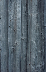 Closeup of old unpainted dark grey wooden fence