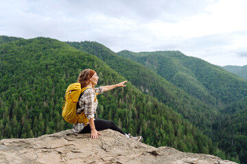 Naklejka premium Woman tourist on top of mountain enjoying views of nature. Lifestyle, adventure, nature, active life.