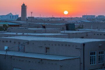 The sun setting over the town of Khiva. - 776224382