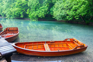 Traditional style wooden rowboats alongside in lake Croatia