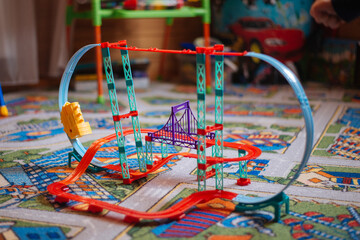 game car slide stands on a colored carpet in the children's room
