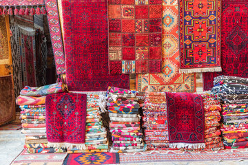 Rugs stacked and hanging outside a store in Bukhara. - 776225590