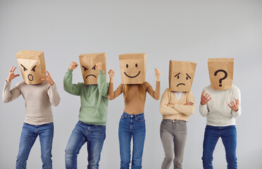 Disguised personalities wearing brown bags on heads show different emotions variety range on happy...