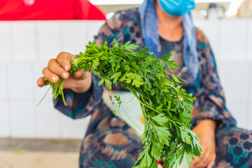 Fresh parsley for sale at a market in Bukhara. - obrazy, fototapety, plakaty