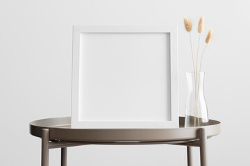 White square frame mockup with a lagurus decoration on the beige table.