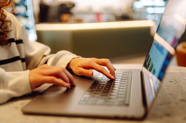 Close-up of hands working on a laptop keyboard.  Freelance, online course. Shopping online. Cyber...