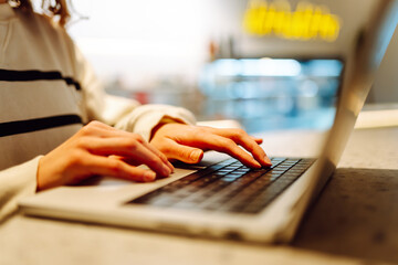 Close-up of hands working on a laptop keyboard.  Freelance, online course. Shopping online. Cyber security concept