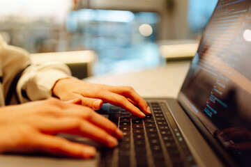 Close-up of hands working on a laptop keyboard.  Freelance, online course. Shopping online. Cyber...