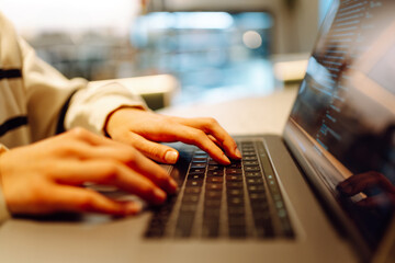 Close-up of hands working on a laptop keyboard.  Freelance, online course. Shopping online. Cyber security concept