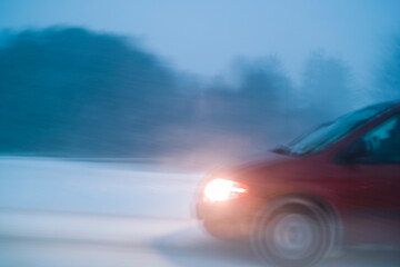 Car driving through winter snow storm - 776241756