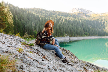 Adventure woman feeling happy among amazing mountains, forest and lake, enjoy the nature landscape....