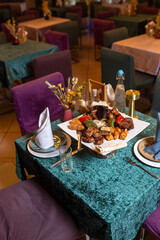 assorted different kebabs on a white plate in a restaurant
