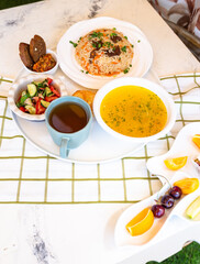 Uzbek Food with Tea and Traditional Uzbek Bread on Checkered Tablecloth