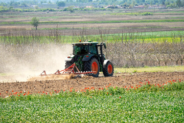 rear view of tractor preparing the fields for cultivation - 776261582