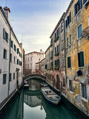 Fototapeta na wymiar View of Venice water canals and old building's facades. Italian historic architecture