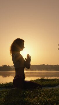 Young woman enjoying yoga exercises outdoors, feeling calm and contentment amidst natural beauty, promoting vitality and happiness.