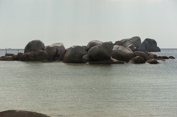 Huge granite stones inside the sea in front of the beach near Tanjung Tinggi, Belitung, Sumatra, Indonesia.