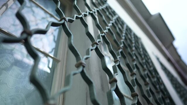 Metal Fence Design - Window Protection Patterns on Building Facade
