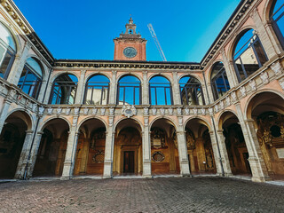 Fototapeta na wymiar View of old building with arched windows in Bologna, Italy. Old medieval Italian architecture