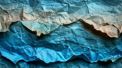   A tight shot of paper depicting mountainous folds against a backdrop of azure sky