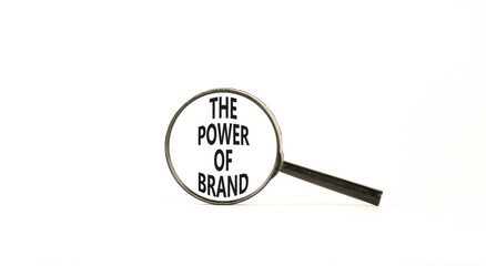 The power of brand symbol. Concept words The power of brand on beautiful magnifying glass. Beautiful white table white background. Business the power of brand concept. Copy space.