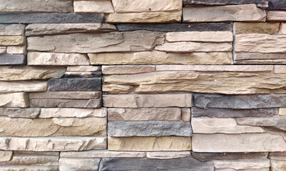 The wall is made of natural bricks in a natural color, the masonry is made of limestone. Texture for indoor or outdoor background, interior.