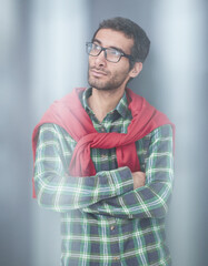 Fototapeta premium Stylish young man posing in the studio on gray background